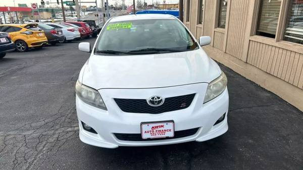 Side profile of a 2010 Toyota Corolla LE showcasing its sedan body style