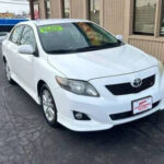 Front view of a white 2010 Toyota Corolla LE sedan