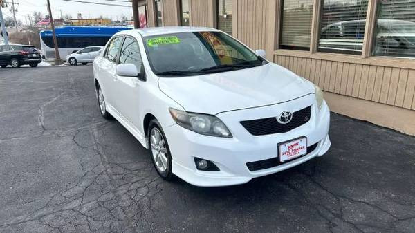 Front view of a white 2010 Toyota Corolla LE sedan