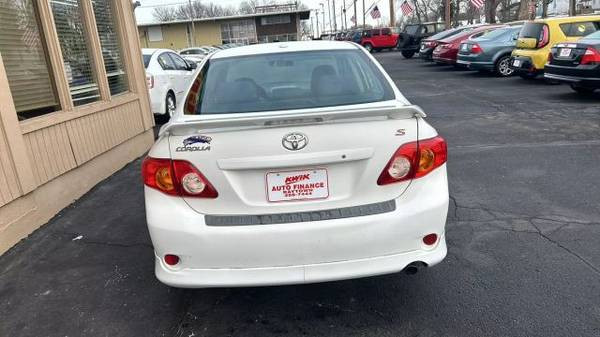 Badge detail on the rear of a 2010 Toyota Corolla LE displaying the model name