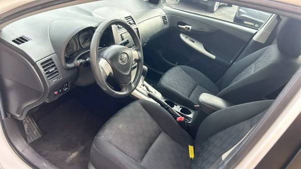 Image focusing on the side mirror and front window of the 2010 Toyota Corolla LE