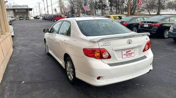 Rear view of a 2010 Toyota Corolla LE showing the taillights and trunk