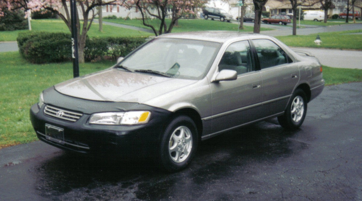 Front angle of a 1997 Toyota Camry in 'Antique Sage' color, featuring the front grille and headlights of this reliable sedan.