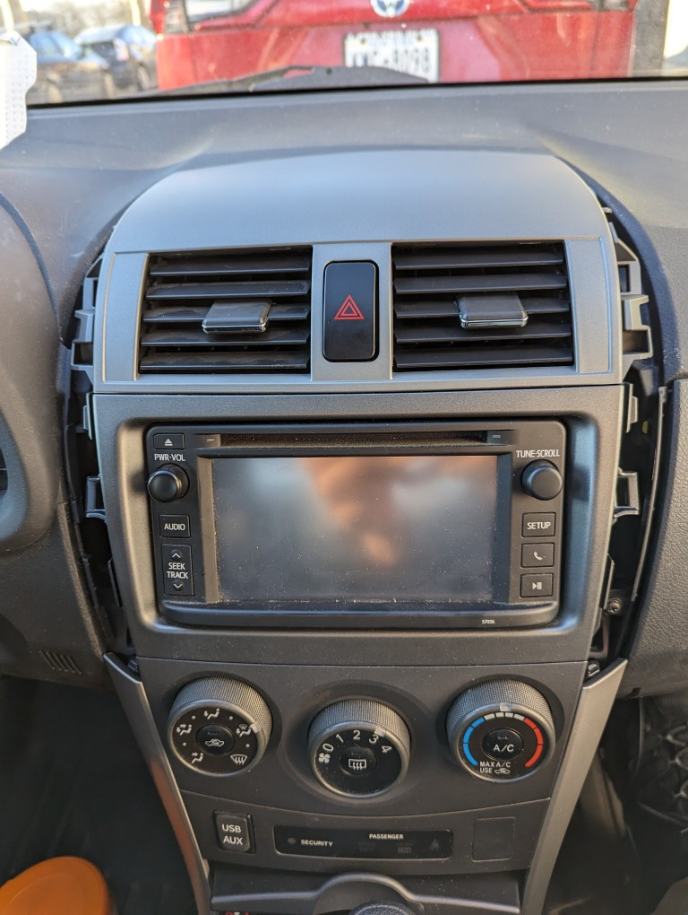Replacement air vent assembly clicked into place in the 2013 Toyota Corolla dashboard.