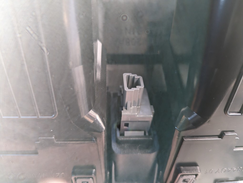 Caution lights switch being disconnected from the 2013 Toyota Corolla air vent assembly.