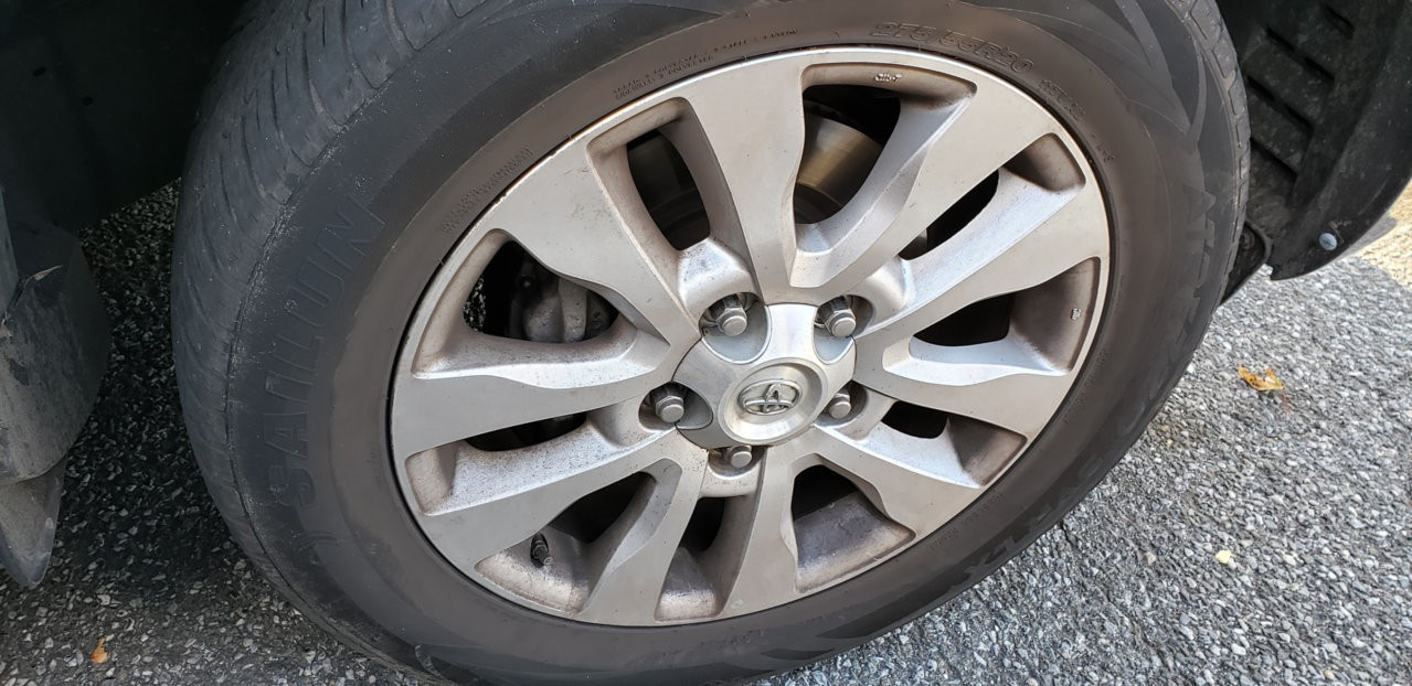 Front view of a Toyota Sequoia showing upgraded wheels and brake system, emphasizing enhanced vehicle performance.