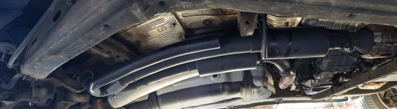 New Dirty Deeds exhaust system installed underneath a Toyota Sequoia, showing the completed performance modification.