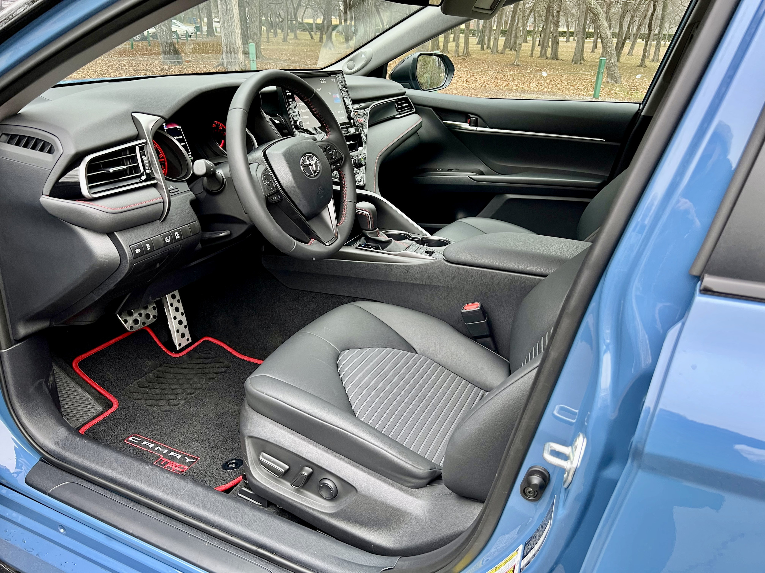 Sport SofTex-trimmed front seats of the 2022 Toyota Camry TRD with red accents and TRD logo on the headrest.