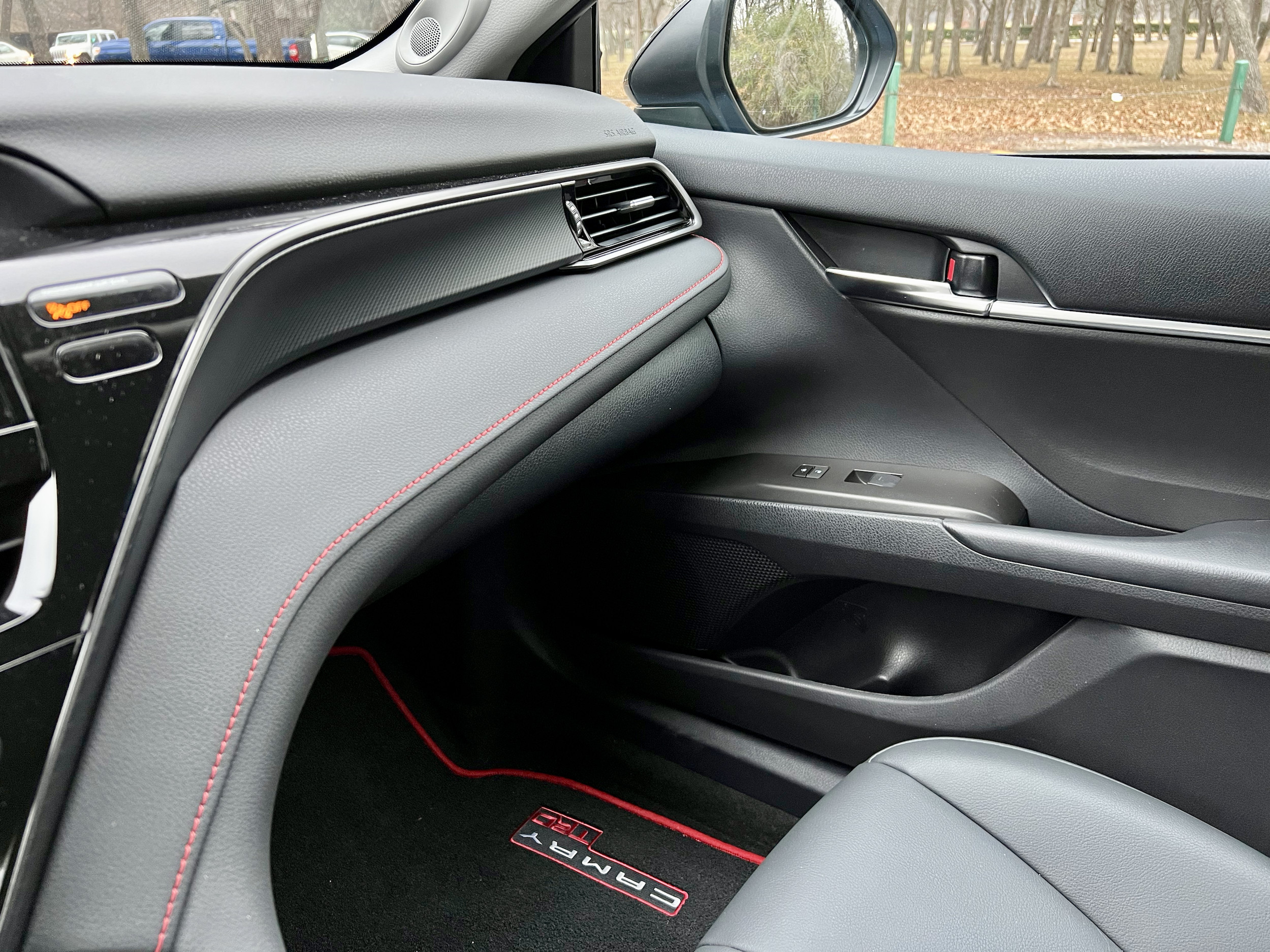 Interior trim of the 2022 Toyota Camry TRD, showcasing the 9-inch touchscreen display and JBL speaker system.