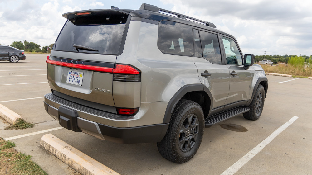 Rear three-quarter view of the 2024 Lexus GX 550 Overtrail, emphasizing its spacious cargo area, tailgate design, and overall adventurous styling.