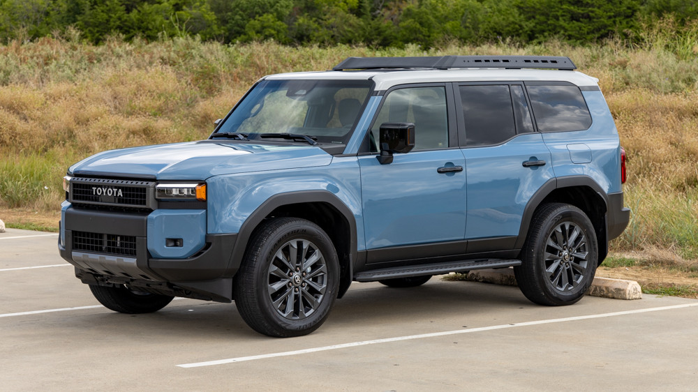 Front view of the 2024 Toyota Land Cruiser Premium in Smoky Blue, showcasing its rectangular headlights and rugged design, ideal for off-road enthusiasts and daily commutes.