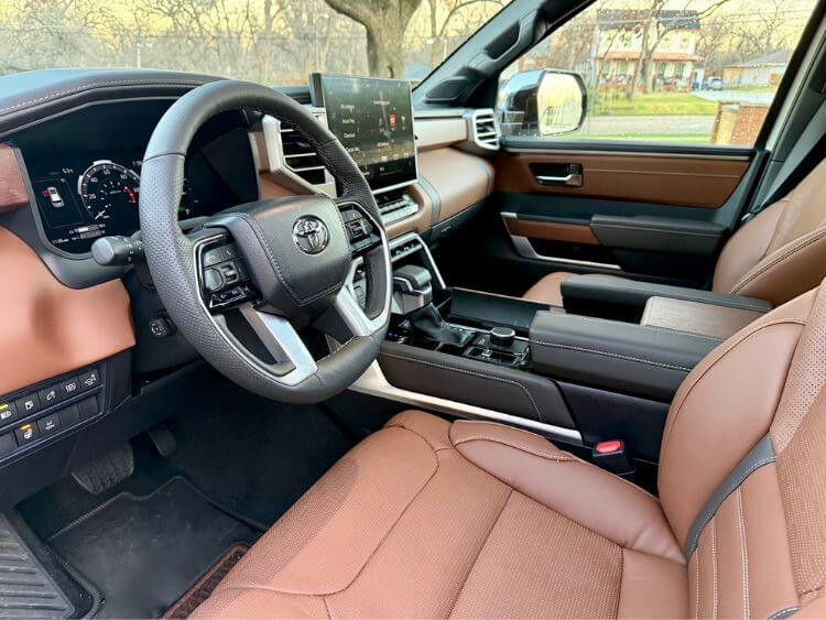 Luxurious brown leather interior of the 2025 Toyota Sequoia 1794 Edition, featuring a 14-inch infotainment screen and walnut wood trim.