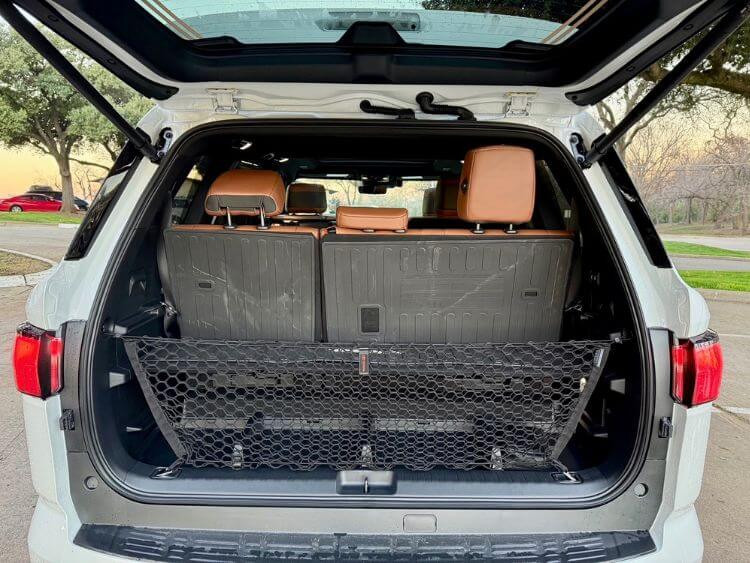 Cargo area of the 2025 Toyota Sequoia with the adjustable shelf, showcasing storage capacity and power folding third-row seats.