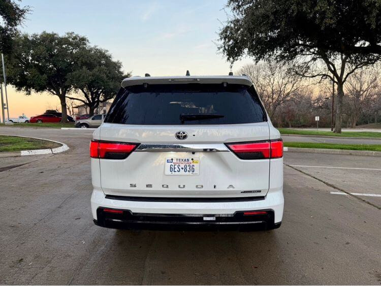 Rear view of the 2025 Toyota Sequoia 1794 Edition, highlighting the taillights, spoiler, and 20-inch alloy wheels.