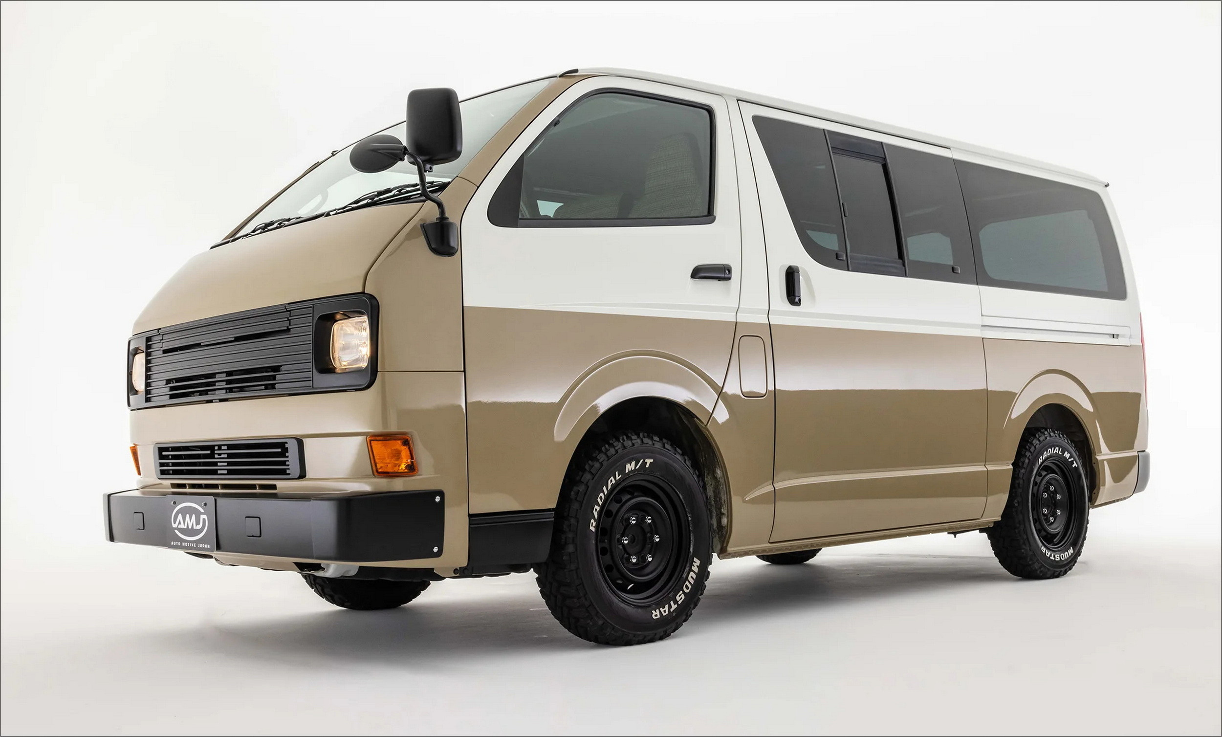 Front perspective of a silver Toyota HiAce Vanace Type 3 showcasing square headlights, retro bumper, and chrome wheels.