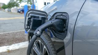 Charging port closeup of the 2024 Toyota bZ4X Limited electric car, highlighting range concerns.