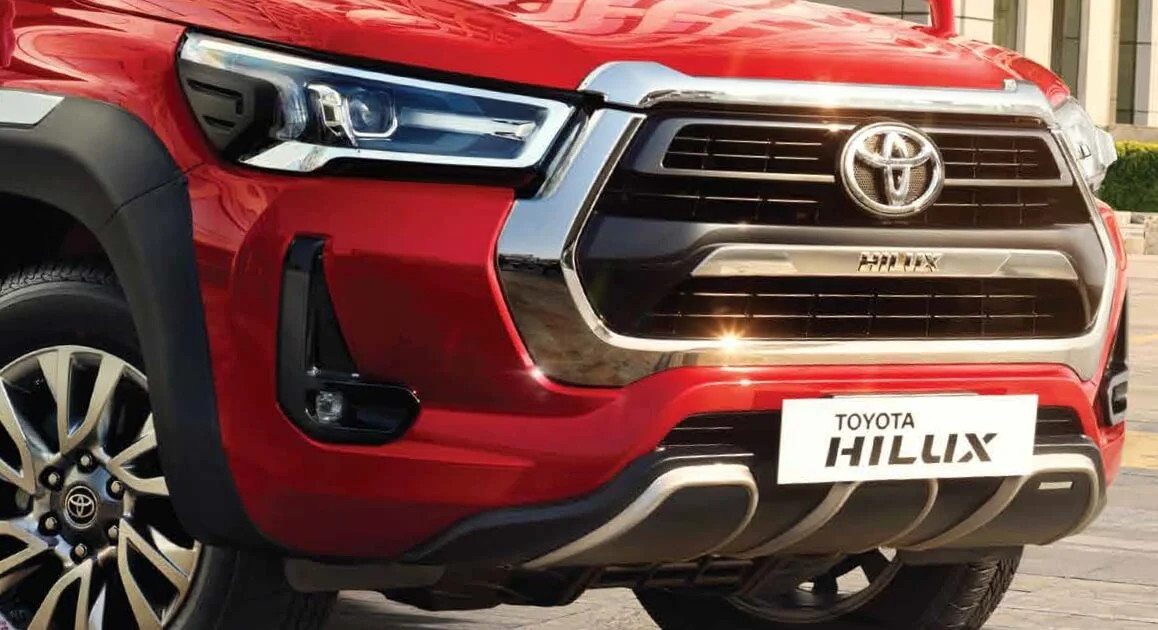 alt text: The front of the Toyota Hilux showcasing its distinctive grille, LED headlights, and robust bumper.