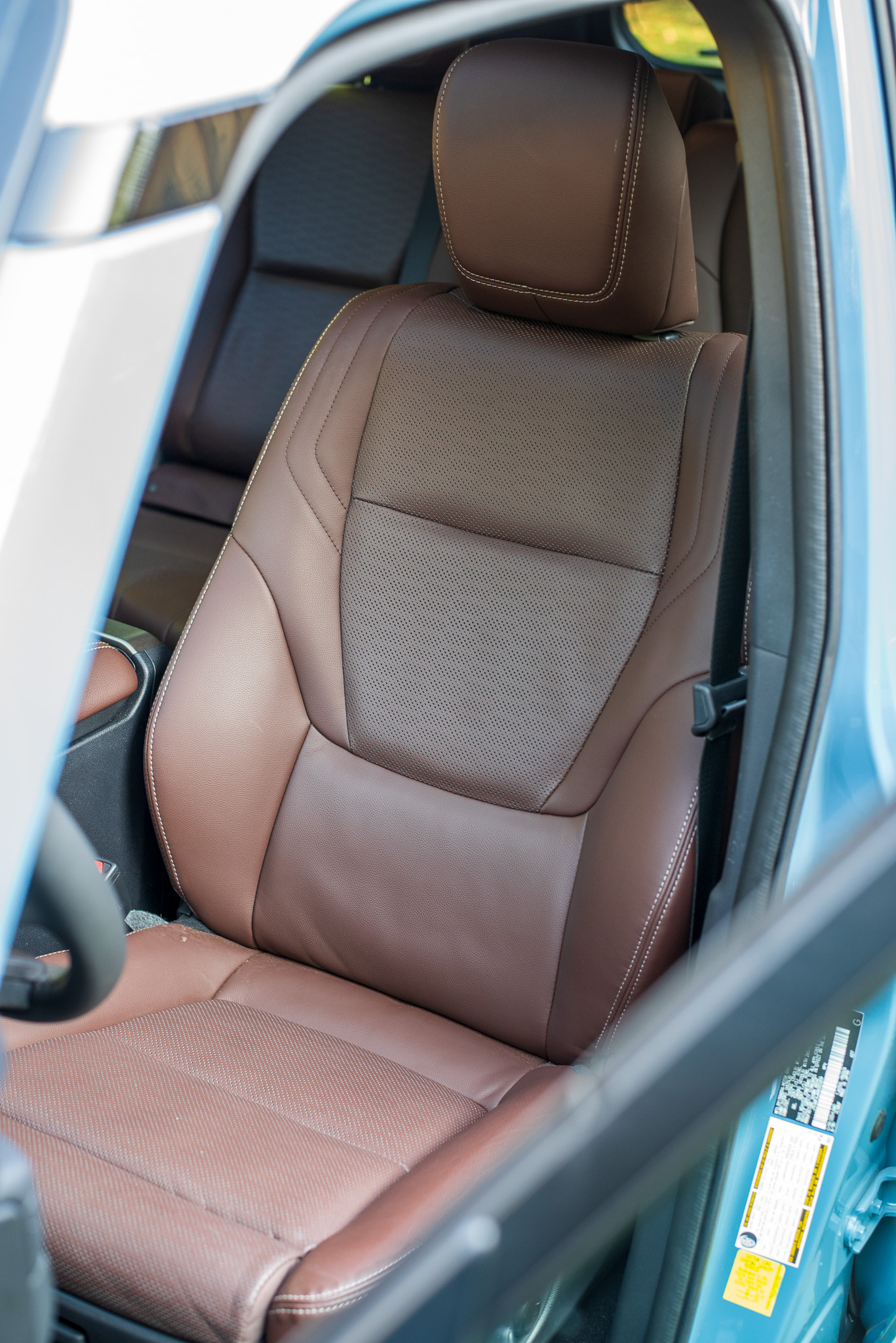 Front interior view of the 2024 Toyota Land Cruiser cabin highlighting the steering wheel and dashboard layout.