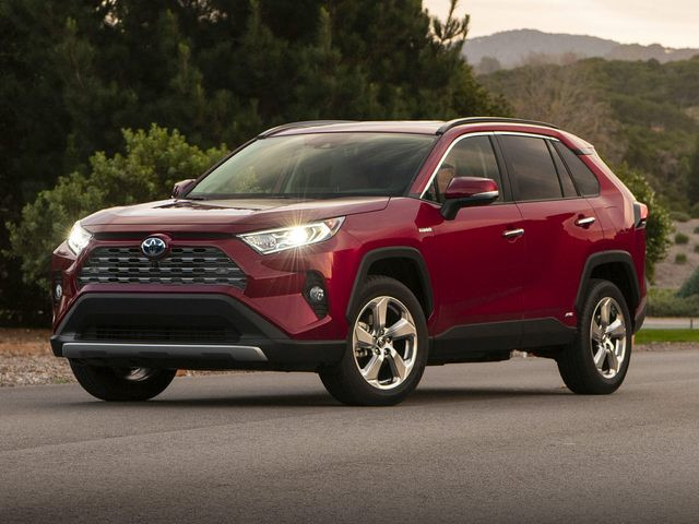 Exterior view of a White Toyota RAV4 showcasing its modern SUV design and clean lines