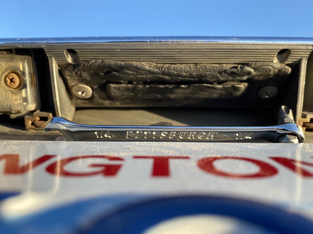 Removing the screws from the Toyota hatch button assembly.