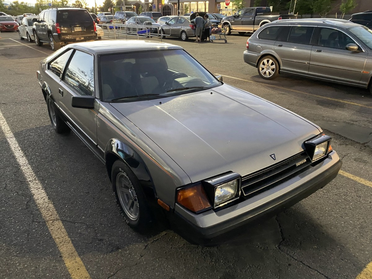 Side profile of a 1985 Toyota Celica GT-S highlighting its sporty silhouette, flared fenders, and classic wheels.