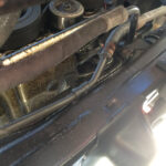 Close-up view of oil leak underneath a Toyota Tacoma, highlighting the potential need for a toyota mechanic.