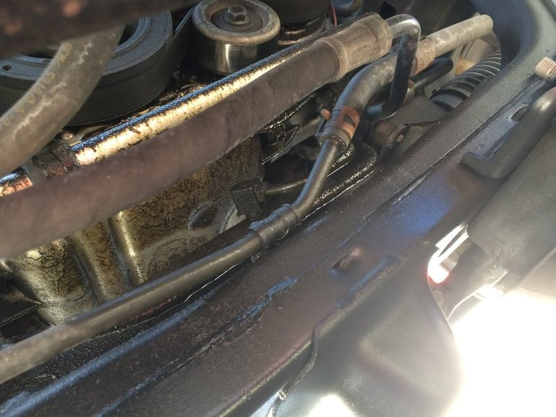 Close-up view of oil leak underneath a Toyota Tacoma, highlighting the potential need for a toyota mechanic.