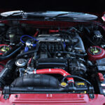 Engine bay of a 1990 Toyota Supra after initial cleaning showing overall layout