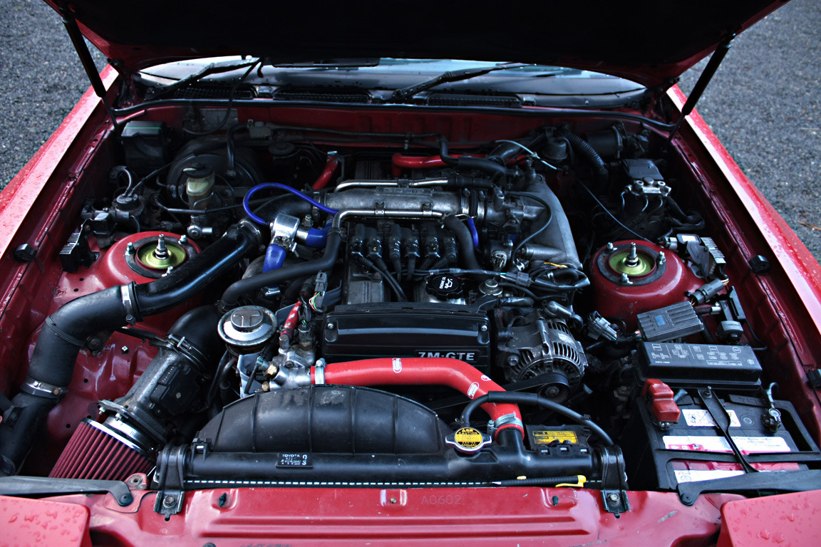 Engine bay of a 1990 Toyota Supra after initial cleaning showing overall layout