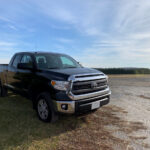 A clean 2014 Toyota Tundra in black parked in a driveway.