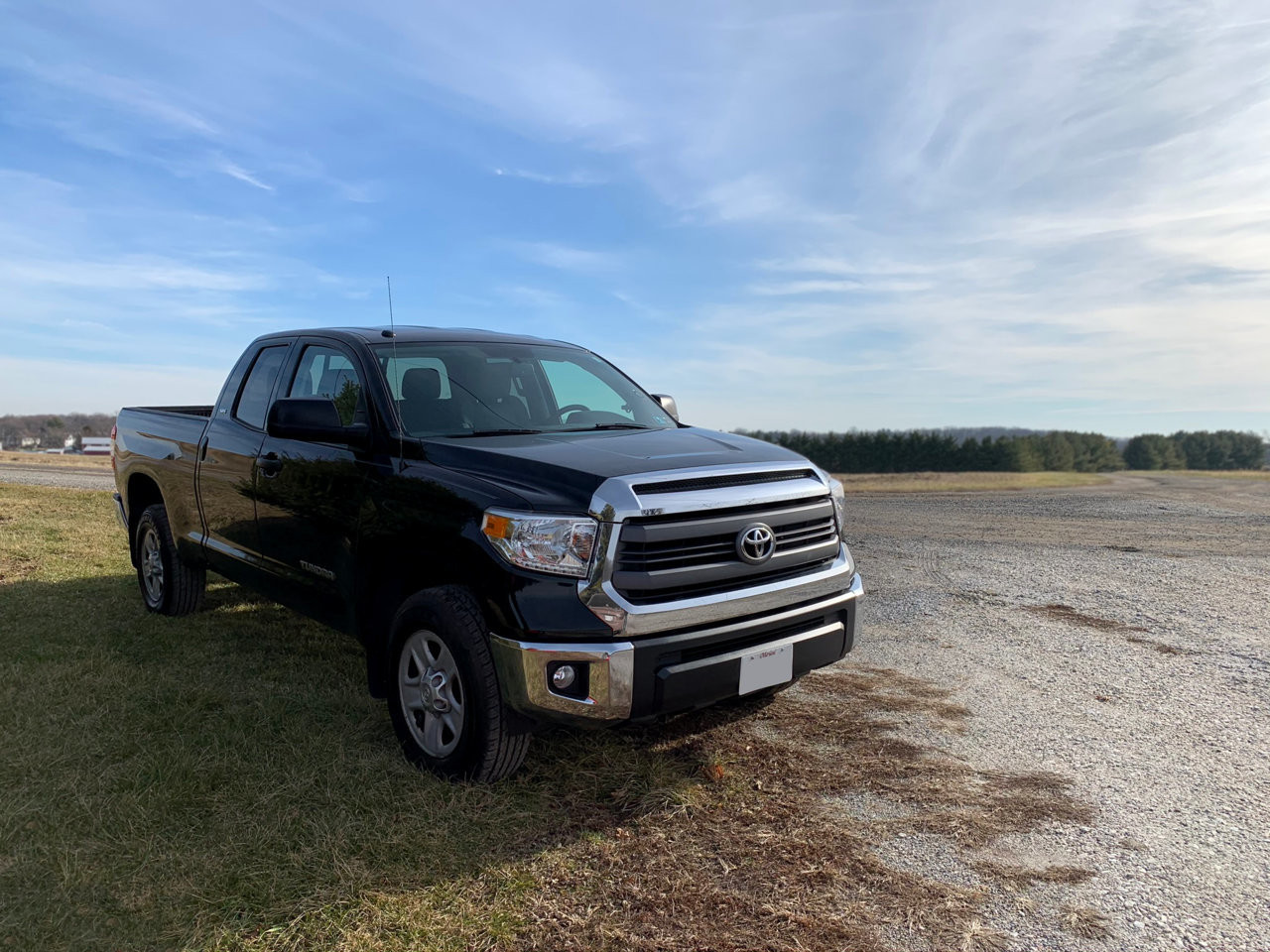 A clean 2014 Toyota Tundra in black parked in a driveway.