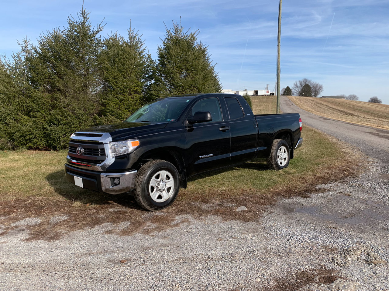 Close-up view of the rear of the black Toyota Tundra highlighting its chrome trim and badging.