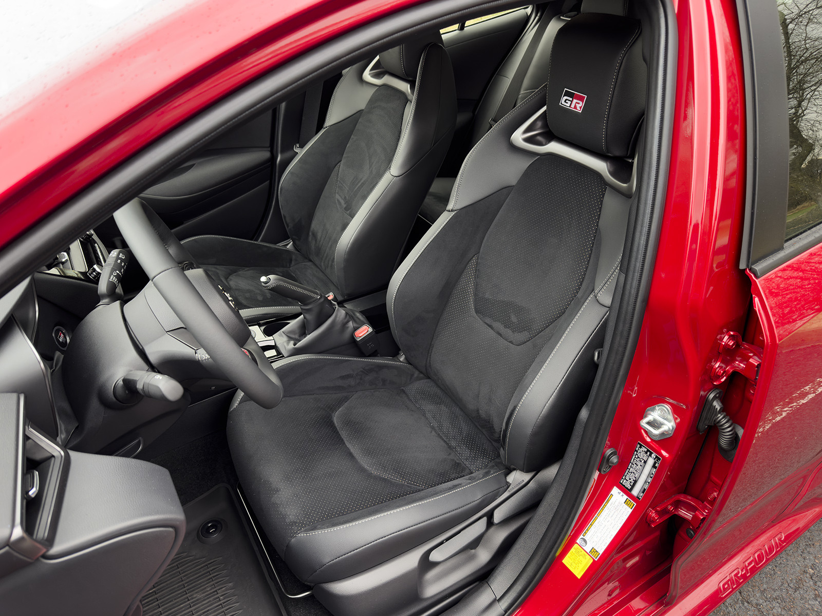 alt text: Close up view of the interior door handle and window controls of a Toyota Corolla