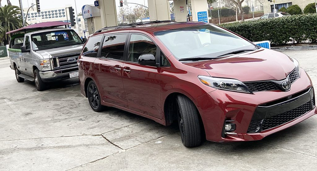 The 2020 Toyota Sienna SE next to a converted Ford full-size van