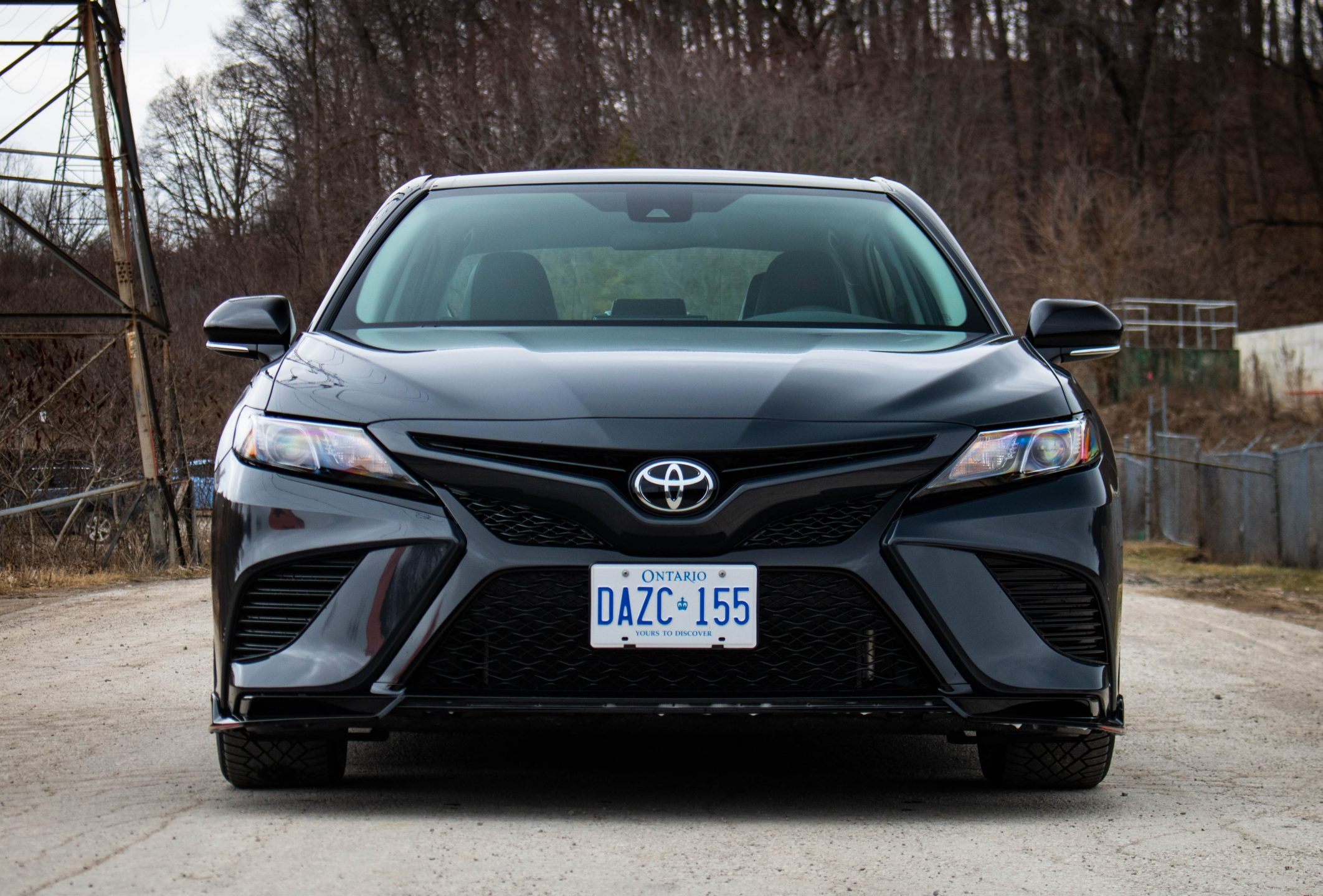 Low angle front view of the 2024 Toyota Camry TRD V6, emphasizing its ground-hugging stance and sporty design.