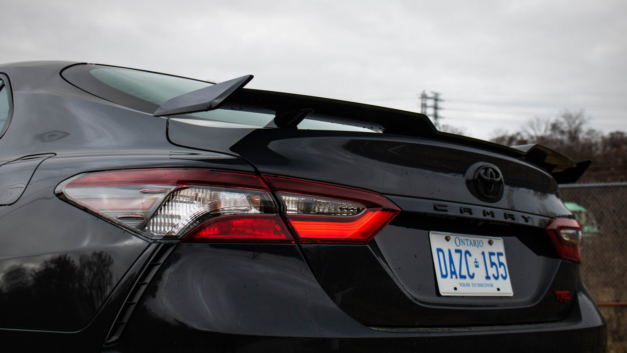 Front angled view of the 2024 Toyota Camry TRD V6, showcasing its aggressive front fascia and headlights.