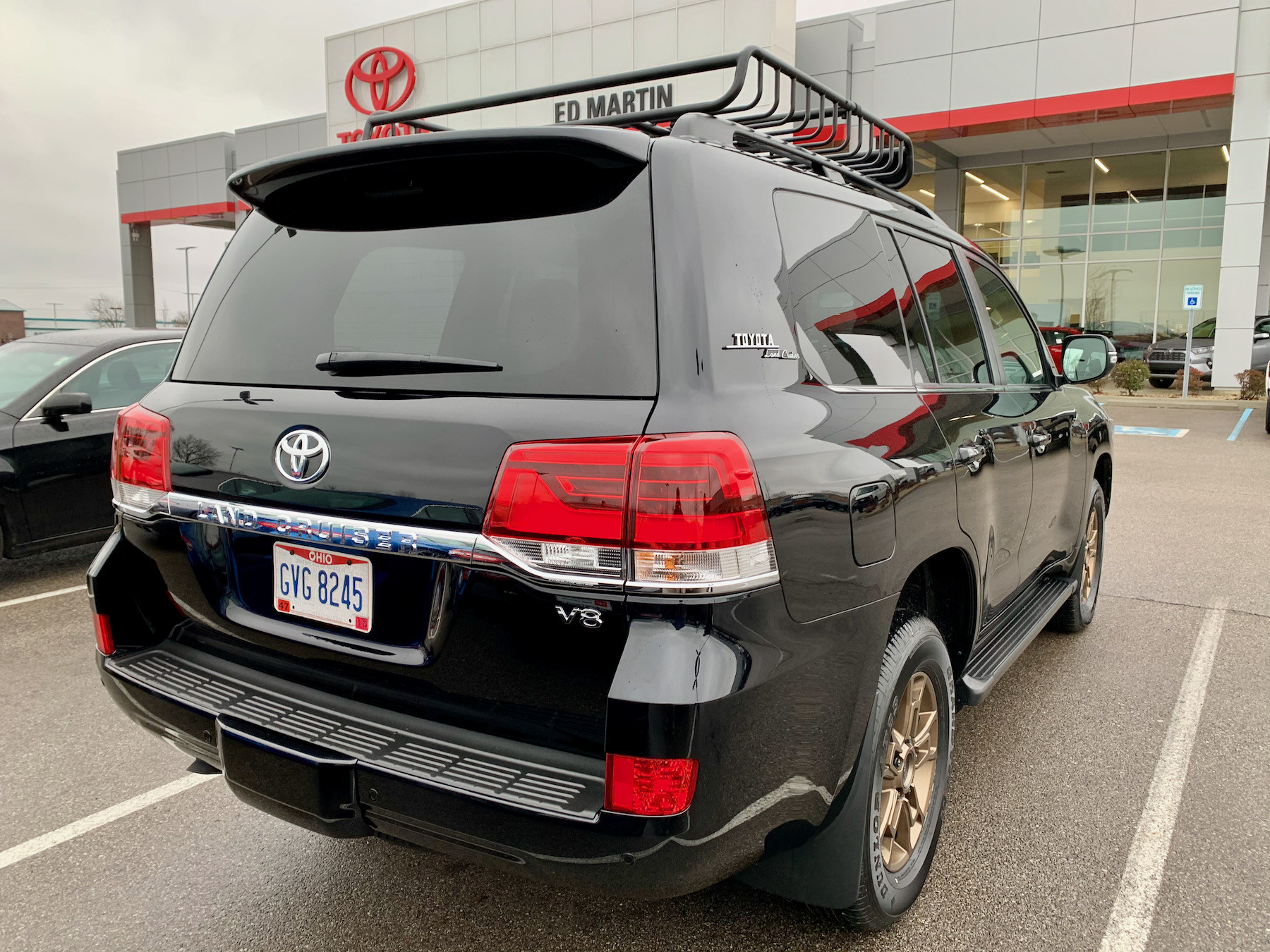 Front view of the black 2021 Toyota Land Cruiser Heritage Edition, showcasing its classic design and swapped fog lights.