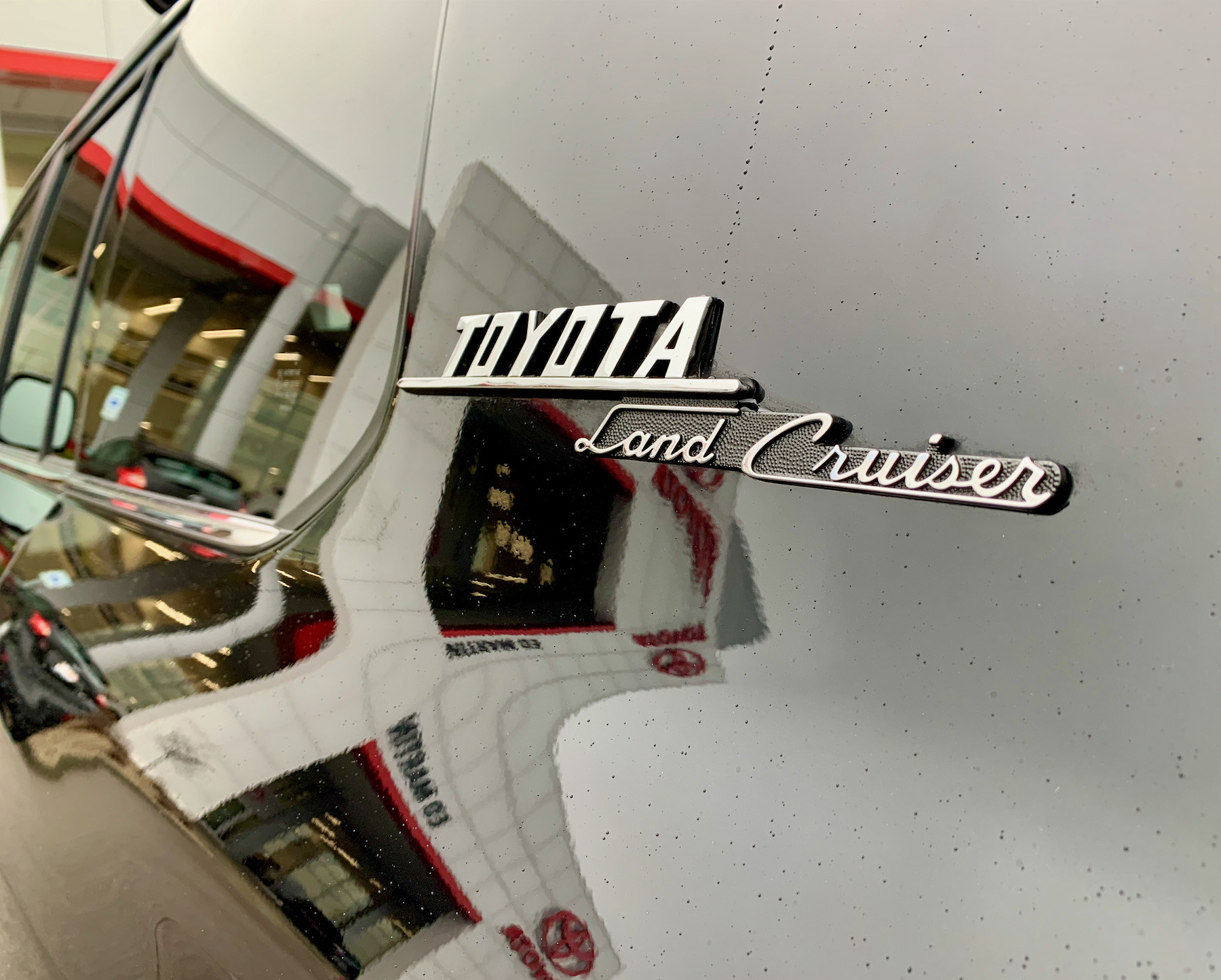 Close-up of the 2021 Toyota Land Cruiser's rear cargo area, featuring a Canvasback Tailgate Cover and modifications for storage.