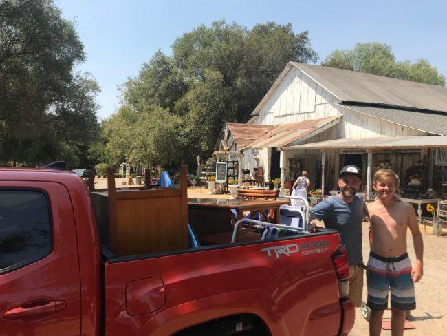 Furniture in the bed of a Toyota Tacoma truck.