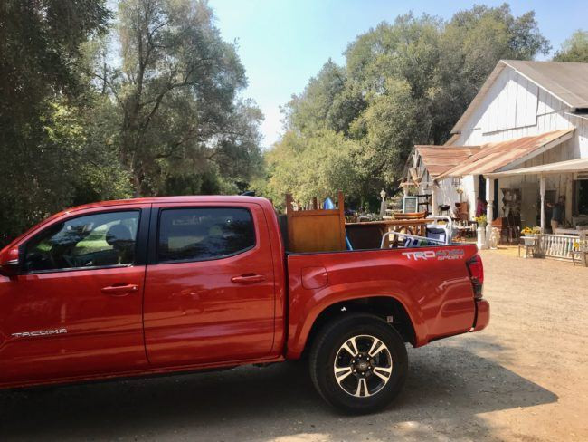 Beach chairs and boogie boards in the bed of a Toyota Tacoma truck.