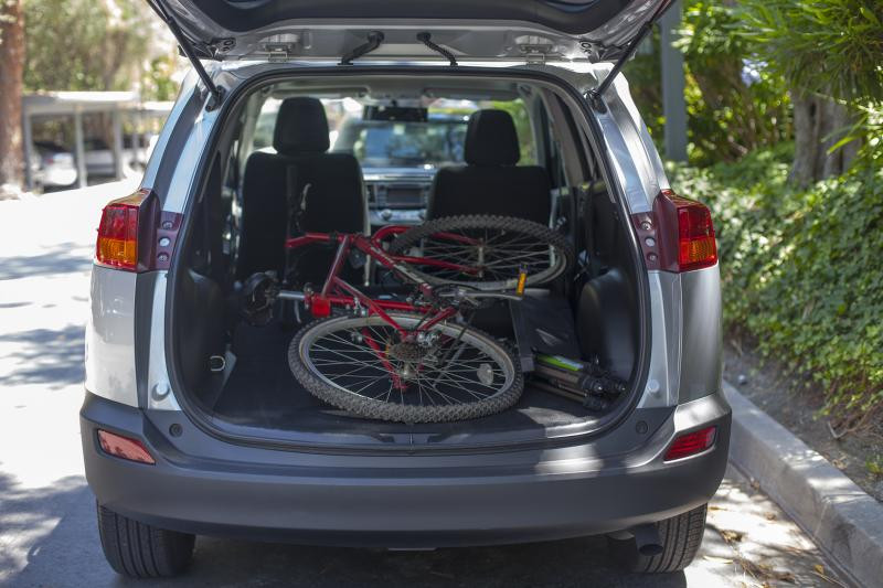 Rear cargo area of the 2015 Toyota RAV4, demonstrating its cargo capacity. The alt text is: 2015 Toyota RAV4 XLE cargo space with folded rear seats.