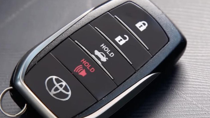 Close-up of a modern Toyota key fob highlighting its sleek design and keyless entry features, used to illustrate the convenience of key fobs before discussing battery replacement.