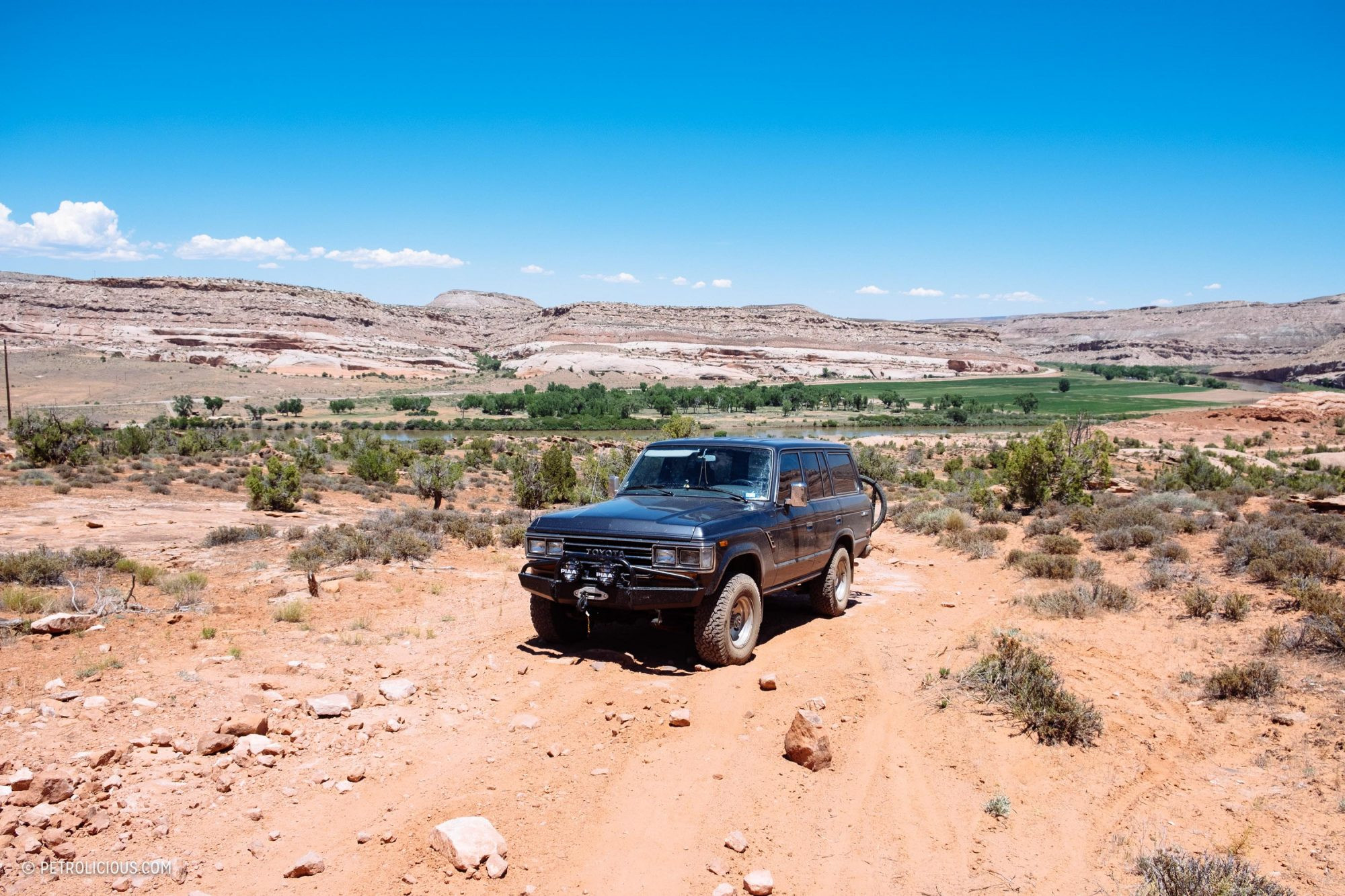 Rear view of an old Toyota Land Cruiser highlighting its classic tailgate and spare tire mount