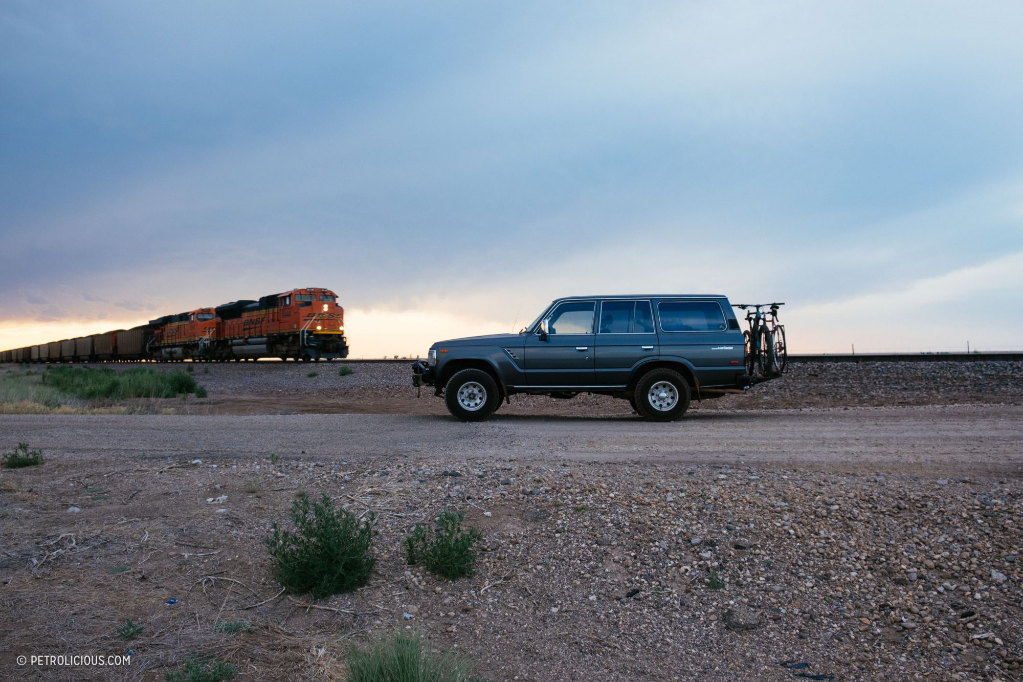 Side view of a classic Toyota Land Cruiser with bicycles mounted on the back, ready for adventure