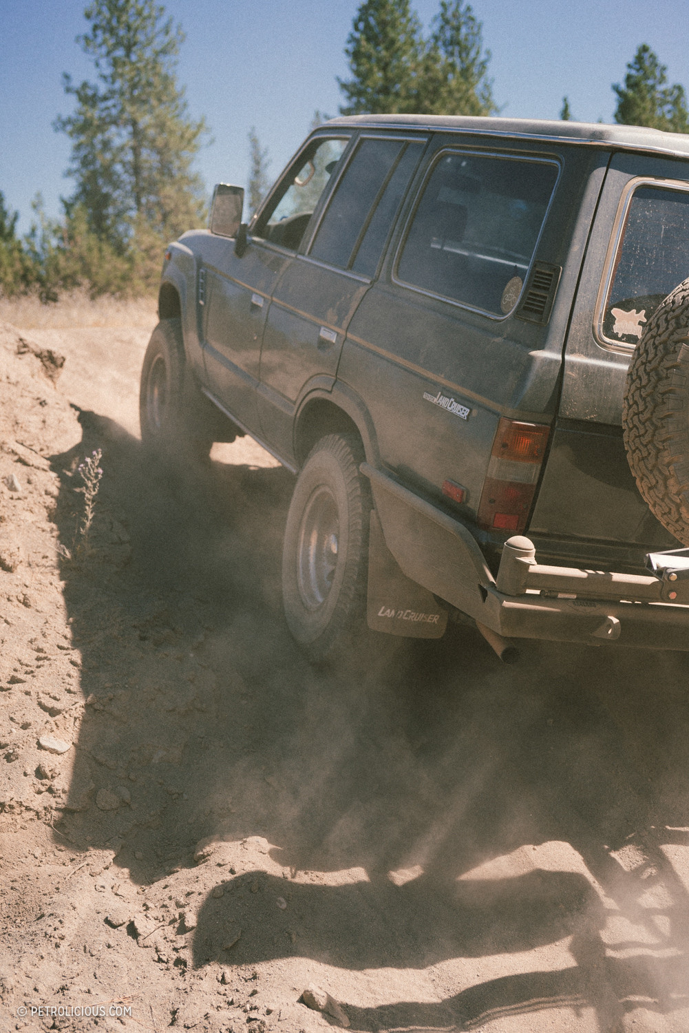 Toyota Land Cruiser driving on a winding mountain road