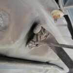 Releasing a Toyota Tundra hood latch with a screwdriver
