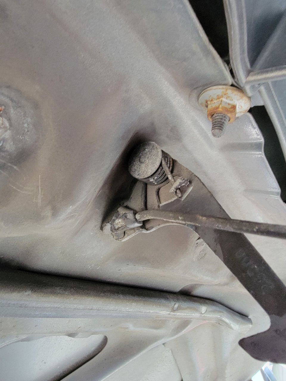 Releasing a Toyota Tundra hood latch with a screwdriver