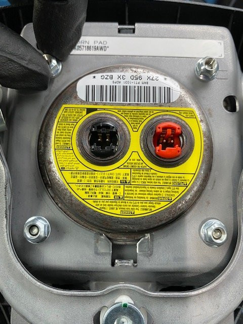 Removing only the 4 nuts to release the airbag