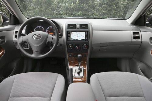 Toyota Corolla with aftermarket wheels and performance exhaust system, showcasing potential customization options
