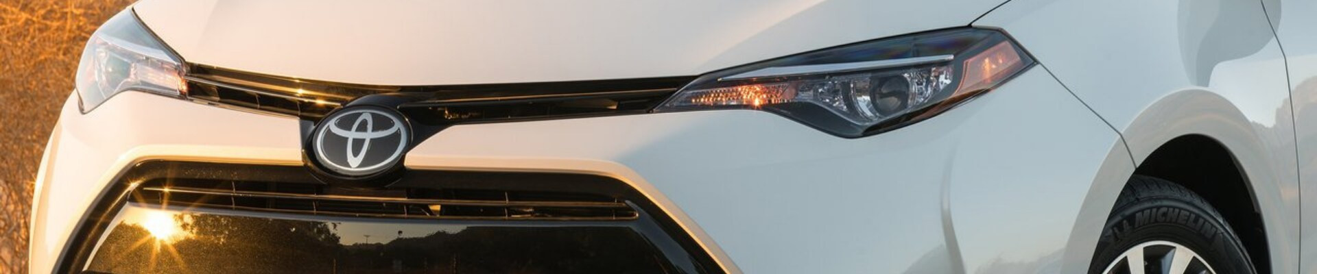 Used Toyota Camry parked on a sunny day, showcasing its sleek design